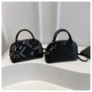 Detail of shell bags with pixel geometry and black leather textures on minimal stands