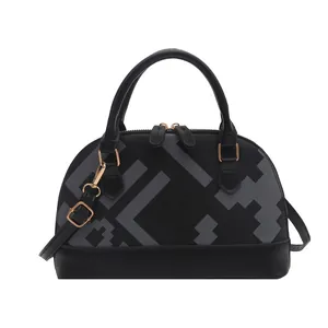 Black leather shell crossbody bag with geometric pixel pattern and gold-tone metal hardware