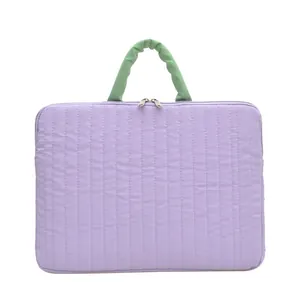 Light purple quilted laptop sleeve with soft green handle and double zipper closure