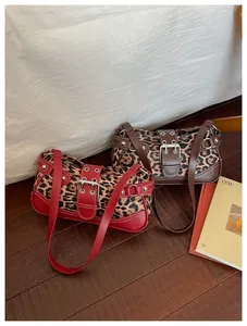 Detail view of leopard print shoulder bags with retro metal buckles and rivet accents