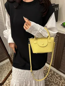Chic yellow lychee leather mini handbag with top handle and detachable shoulder strap