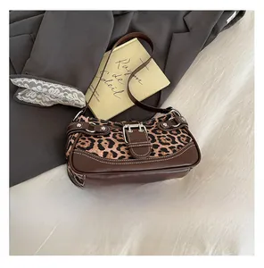 Leopard print canvas shoulder bag with belt buckle and phone for size comparison