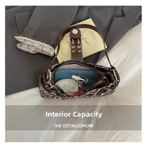 Internal capacity of leopard print handbag showing phone, lipstick and essentials
