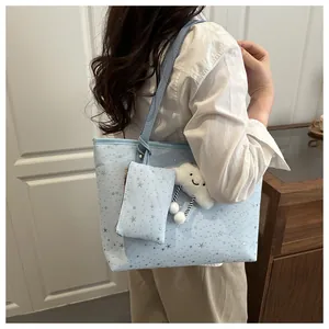 Light blue star print tote bag detail showing small purse and white cloud charm