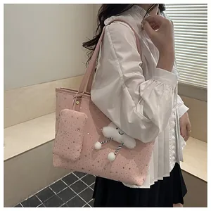Detail of pink polka dot tote bag with silver stars and fluffy cloud charm pendant