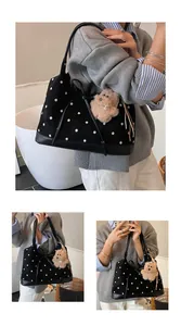 Detailed view of polka dot tote bag with long leather straps and cute bear pendant