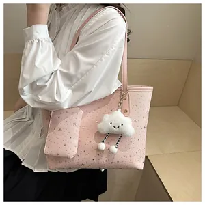 Pink tote bag detail with silver star pattern and cute white plush cloud charm accessory