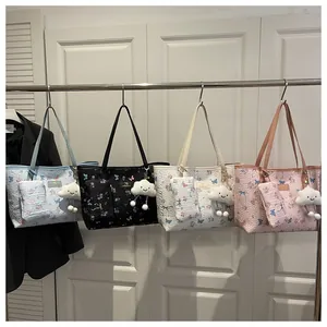 Close-up of four floral tote bags in blue, black, white, and pink with cloud charms