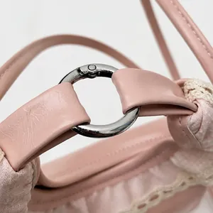Detail of pink PU leather purse showing high-quality silver metal ring and lace trim
