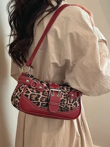 Vintage leopard print shoulder bag with red faux leather trim and silver rivets decor
