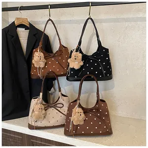 Polka dot tote bags in black, brown, and cream with bow details and plush bear charms
