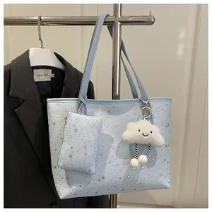 Light blue polka dot tote bag with star patterns and a plush white cloud charm
