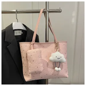 Pink polka dot tote bag detail with star pattern and cute white plush cloud charm