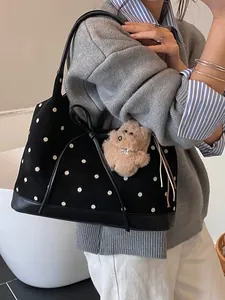Black polka dot tote bag with leather bow detail and plush charm for casual commuting