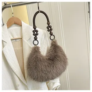 Detail of plush faux fur shoulder bag with brown wooden bead handle and soft texture
