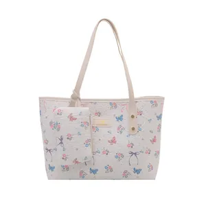 Floral print tote bag with butterfly patterns and matching small coin purse set