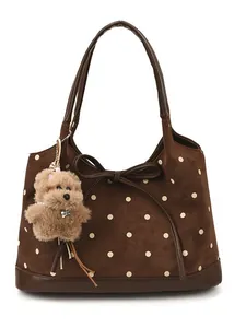 Brown polka dot suede tote bag with large bow detail and cute plush bear charm