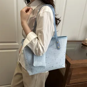 Light blue star pattern tote bag with matching pouch shown on a shoulder model