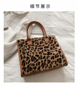 Detailed macro view of leopard print faux fur tote bag with brown leather handles