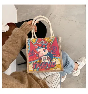 Close-up of linen tote bag with rope handles and trendy cartoon Chinese opera girl print