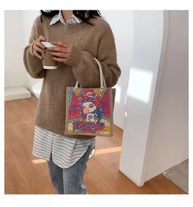Detail of burlap tote bag with a modern cartoon girl illustration and cotton handles