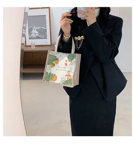 Linen handbag with autumn pumpkin and forest pattern shown in a lifestyle mirror selfie