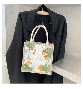 Detail of eco-friendly linen tote bag with botanical prints and braided rope handles