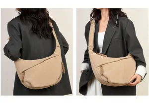 Detailed view of khaki corduroy half-moon crossbody bag with textured stripes and zipper