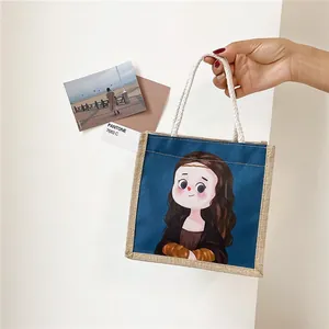 Borsa tote in tela blu con illustrazione cartoon di Monna Lisa e manici in corda intrecciata