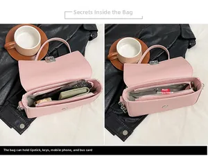 Detail view of pink underarm bag showing interior main pocket with zipper and large capacity