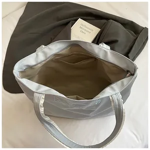 Light blue large capacity tote bag with lace handles and interior compartments