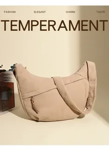 Close-up of corduroy crescent bag showing ribbed texture and woven zipper detail