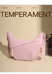 Detailed texture of pink corduroy moon bag featuring woven zipper pull and crossbody strap
