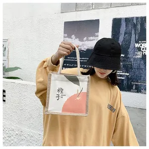 Close-up of mini canvas tote bag with orange print and decorative hemp rope handle