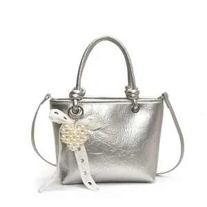 Silver metallic small square handbag with pearl heart charm and bow detail