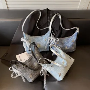 Versatile large capacity denim texture shoulder bag with metallic butterfly accents