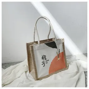 Detail of jute tote bag with thick rope handle and orange illustration on canvas