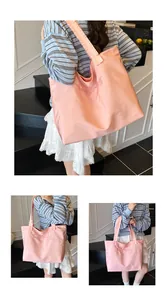 Detailed view of pink tote bag with Iam Crazy embroidery and wide shoulder strap