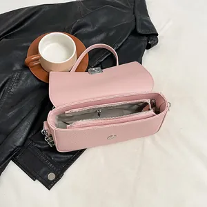 Pink lychee texture crossbody bag with metal twist lock and multi-layer inner storage