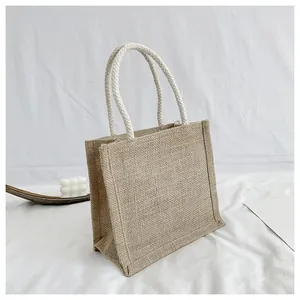 Detail of jute tote bag featuring textured fabric and thick woven cotton rope handles