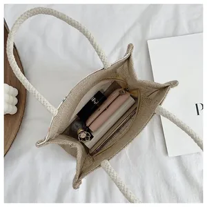 Interior view of beige woven jute tote bag showing zipper closure and spacious capacity