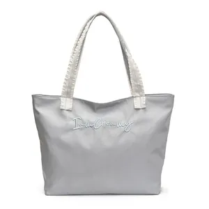 Light blue large capacity tote bag with ruffled lace handles and I am Creamy embroidery