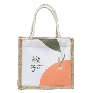 Minimalist canvas and jute tote bag featuring orange print and woven rope handles