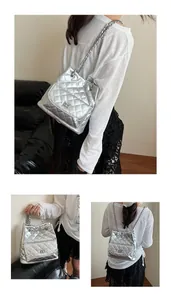 Three-way view of a silver quilted backpack with chain straps showing versatile styling options