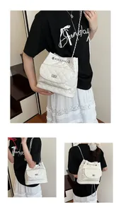 Detail of white quilted chain bag showing convertible straps for backpack or crossbody wear