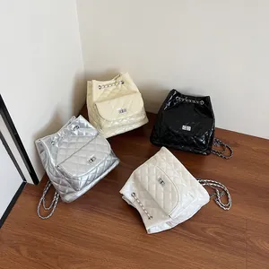 Chic quilted drawstring backpacks in silver, beige, black, and white with chain straps