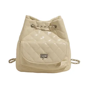 Quilted cream leather backpack for women with metal chain straps and turn-lock closure