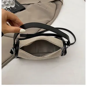 Detail view of the interior compartment with wavy lining and inner pocket of the crossbody bag