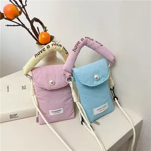 Quilted nylon crossbody phone bag with pearl detail and plush handle in pastel colors