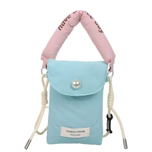 Quilted blue phone bag with pink handle, pearl decoration and white cotton rope strap